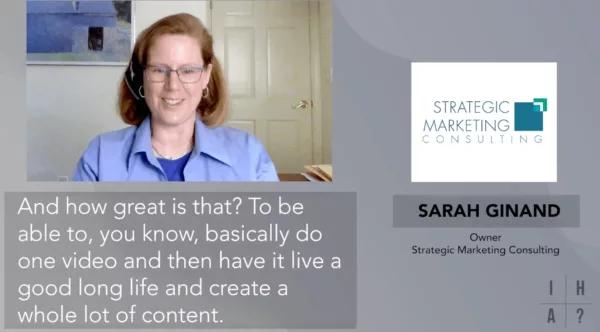 A woman wearing glasses and a blue shirt.