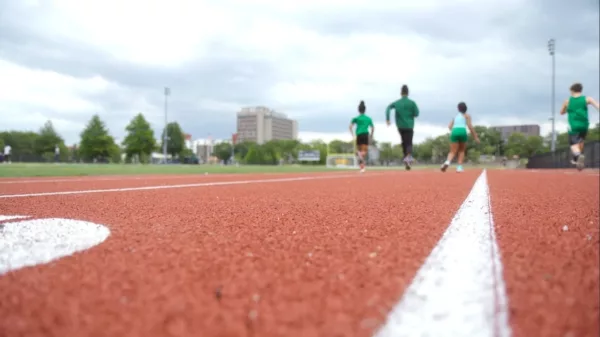 A group of people running on a track.