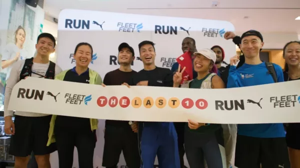A group of people holding up a banner that says run feet.