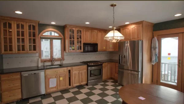 A kitchen with wooden cabinets and stainless steel appliances.
