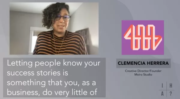 A woman wearing glasses and a striped shirt.