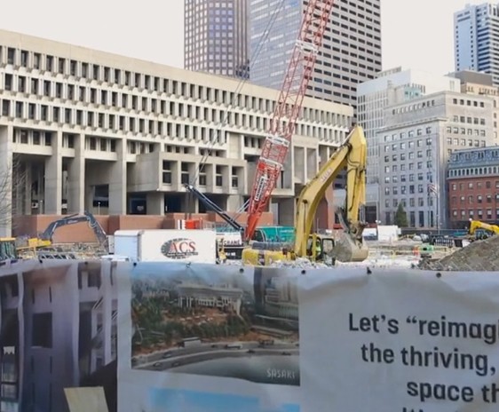A construction site with a sign advertising Boston Video Production Services in front of it.