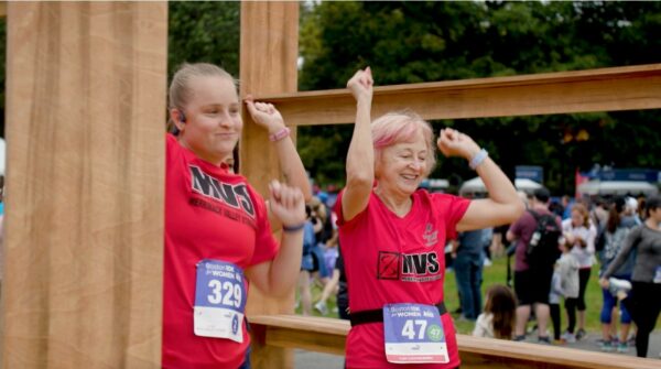 Two women posing for a photo at a race.